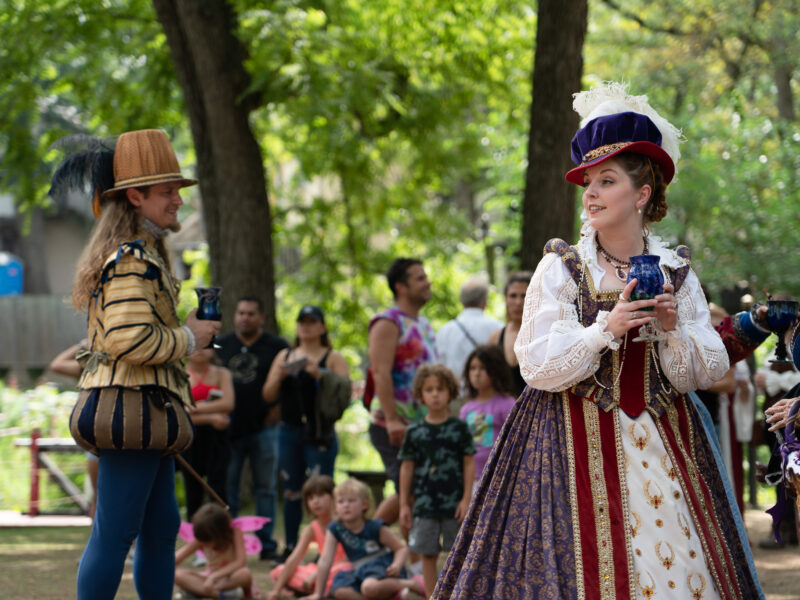 Queen Elizabeth holds a chalice during a renaissance faire