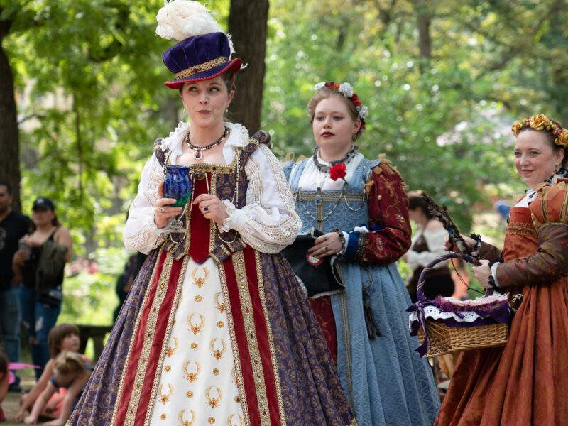 Queen Elizabeth looks to the side during a renaissance faire