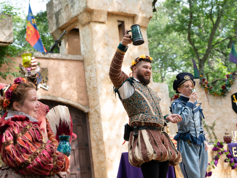 A man raises a toast at a renaissance faire