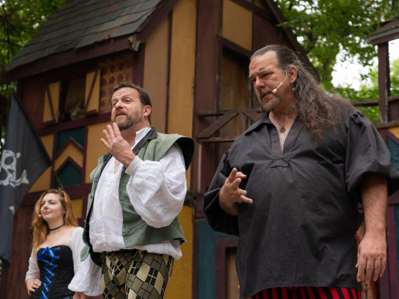 Performers in a renaissance faire show look confused
