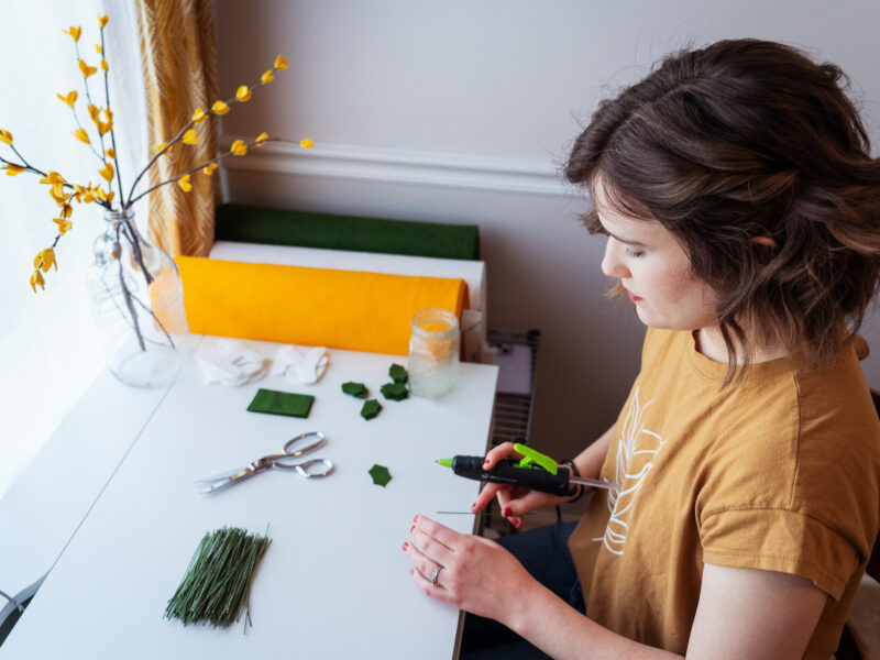 A woman looks down at her desk while working.