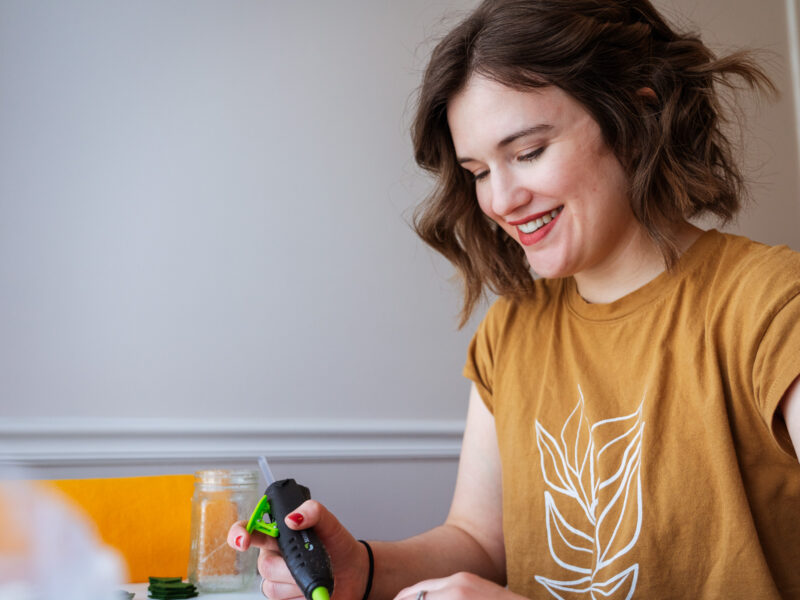 A woman smiles down at her desk while working.